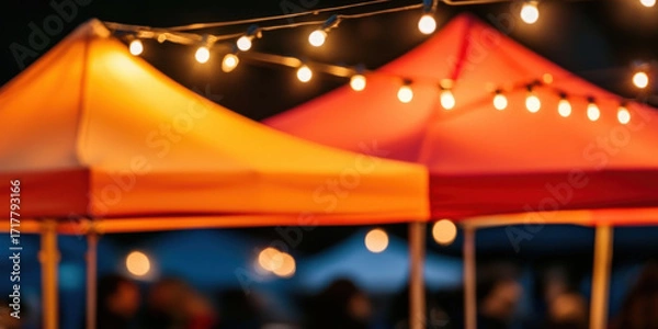 Fototapeta Colorful tents illuminated by string lights create a festive atmosphere, perfect for outdoor events or markets.