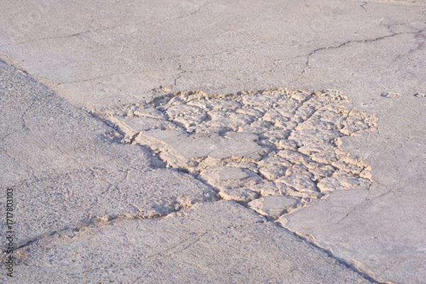 Fototapeta The old badly damaged concrete street background with collapse and broken crack lines texture on surface