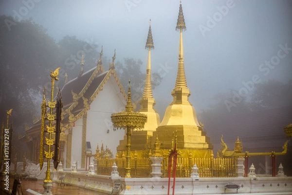 Fototapeta The background of the religious tourist attraction Wat Phra That Doi Tung in the mist in Chiang Rai Province, Thailand, where travelers often stop to make merit.
