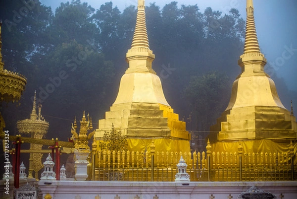 Fototapeta The background of the religious tourist attraction Wat Phra That Doi Tung in the mist in Chiang Rai Province, Thailand, where travelers often stop to make merit.