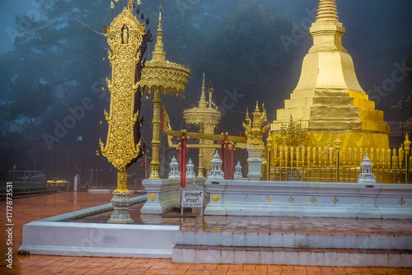 Fototapeta The background of the religious tourist attraction Wat Phra That Doi Tung in the mist in Chiang Rai Province, Thailand, where travelers often stop to make merit.