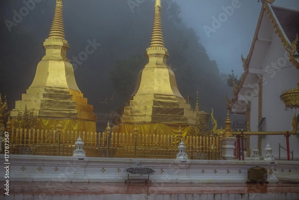 Fototapeta The background of the religious tourist attraction Wat Phra That Doi Tung in the mist in Chiang Rai Province, Thailand, where travelers often stop to make merit.