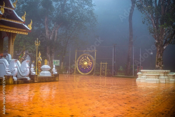 Fototapeta The background of the religious tourist attraction Wat Phra That Doi Tung in the mist in Chiang Rai Province, Thailand, where travelers often stop to make merit.