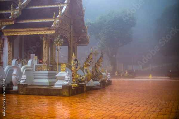 Fototapeta The background of the religious tourist attraction Wat Phra That Doi Tung in the mist in Chiang Rai Province, Thailand, where travelers often stop to make merit.