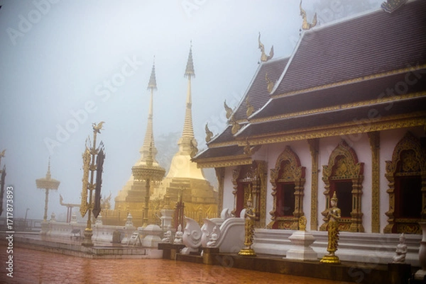 Fototapeta The background of the religious tourist attraction Wat Phra That Doi Tung in the mist in Chiang Rai Province, Thailand, where travelers often stop to make merit.
