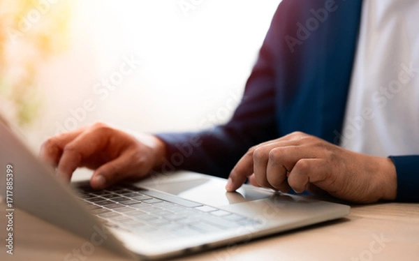Fototapeta Close-up A Businessman typing laptop computer communicates on internet technology on office desk. Workplace, Businessman professional working on new job project. Business technology concept.