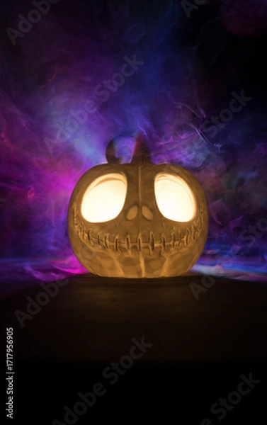 Fototapeta Halloween concept. Creepy silhouette in the dark corridor with pumpkin head. Toned light with fog on background.