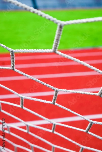 Fototapeta Soccer goal net on the sports field. Selective focus.