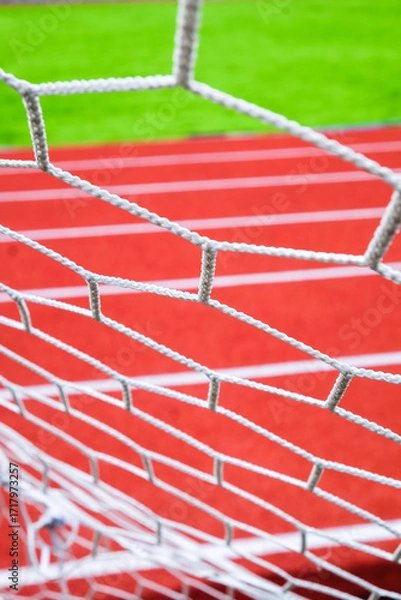 Fototapeta Soccer goal net on the sports field. Selective focus.