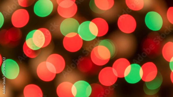 Fototapeta Festive red and green Christmas light bokeh creating an abstract holiday background