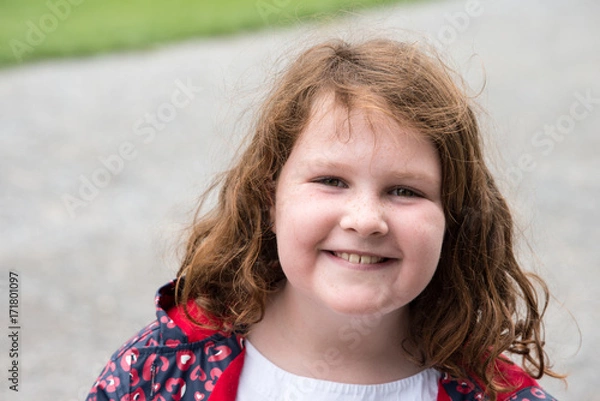 Obraz Young little girl portrait looking and smiling at the camera.