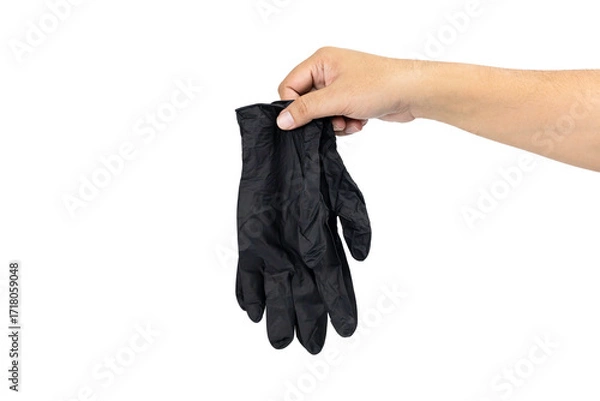 Fototapeta Hand holding black disposable glove isolated on white background with clipping path.