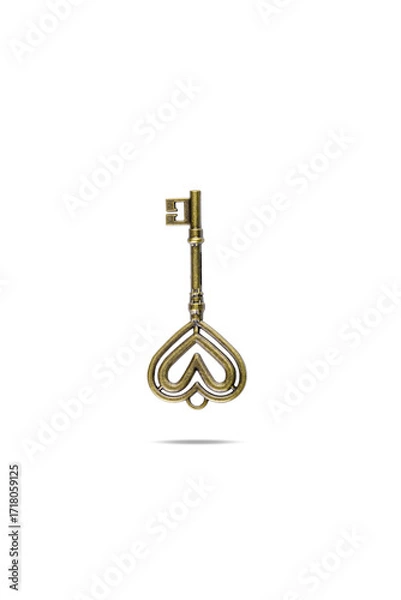 Fototapeta Brass vintage key with heart-shaped head isolated on white background with clipping path.