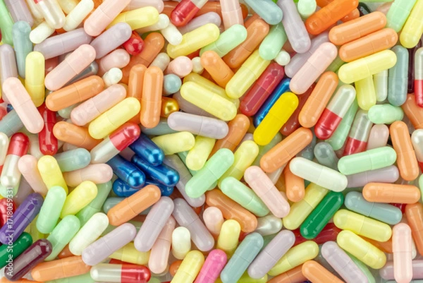 Fototapeta Pile of colorful capsules and pills isolated on white background with clipping path.