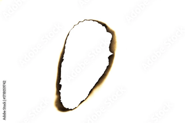 Fototapeta Burnt elongated hole in paper with charred edges isolated on white background with clipping path.