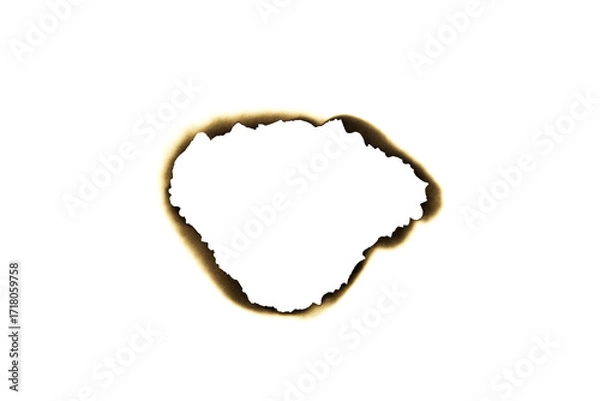 Fototapeta Burnt irregular hole in paper with dark edges isolated on white background with clipping path.