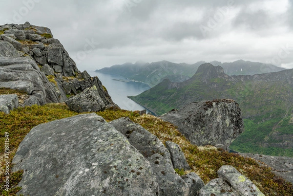 Obraz Mountains on Norwegian senja island. View from hiking trail towards Øyfjorden Barden mountain peak into the fjord. Arctic travel destination in northern europe. Amazing wilderness. Husoy in distance.
