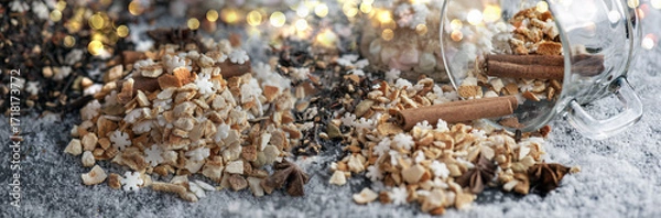Fototapeta winter hot drink ingredient spiled with spices, sugar and glass cup turn over on snowy background