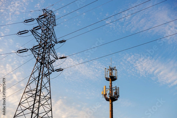 Fototapeta Electro transmission lines and tower gsm telecom network 5g against blue sky, business electricity technology.