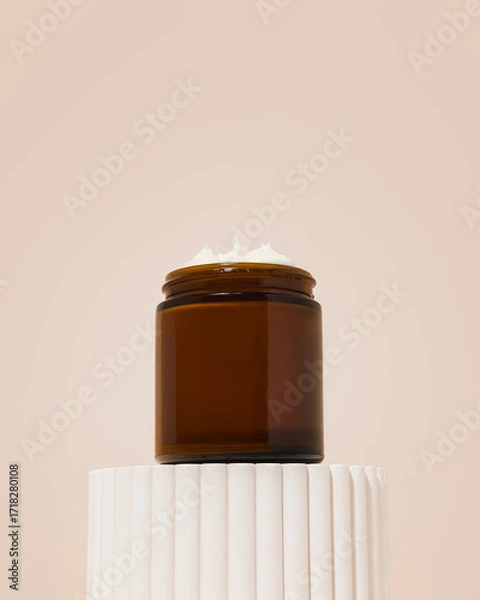 Fototapeta Whipped beef tallow moisturizer on platform with texture coming out of jar