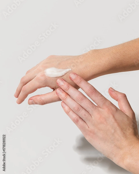 Fototapeta Woman using beef tallow moisturizer on hands