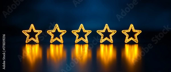 Obraz Five golden stars in a row,  glowing on a dark blue background.