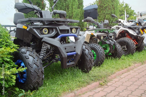 Fototapeta New ATVs stand in a row on the exhibition site