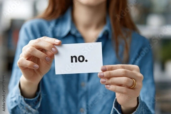 Obraz A Person Holding a Card with the Word 'No' Written on It, Emphasizing a Clear Rejection or Negative Response in a Casual Setting