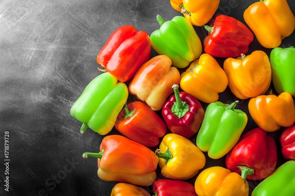 Fototapeta Assortment overhead colorful group of assorted bell peppers in studio on sketchboard. Red, green, orange and yellow.