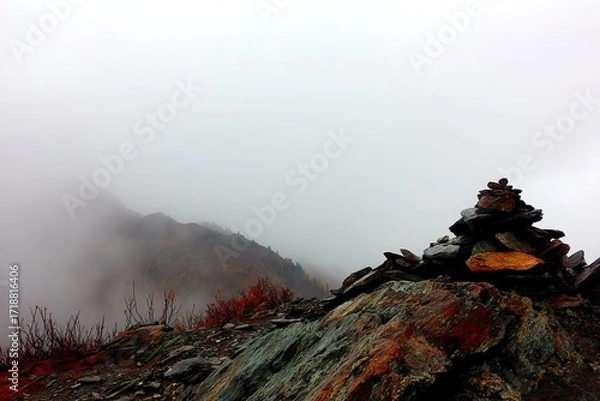 Obraz Misty mountaintop with stone cairn