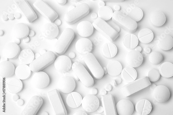 Fototapeta Pile of different pills on white background