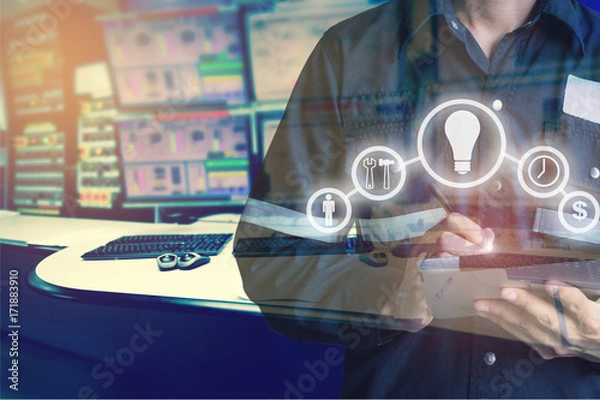 Fototapeta Double exposure of Engineer or Technician man with business industrial tool icons while using tablet with monitor of computers room  for oil and gas industrial business concept
