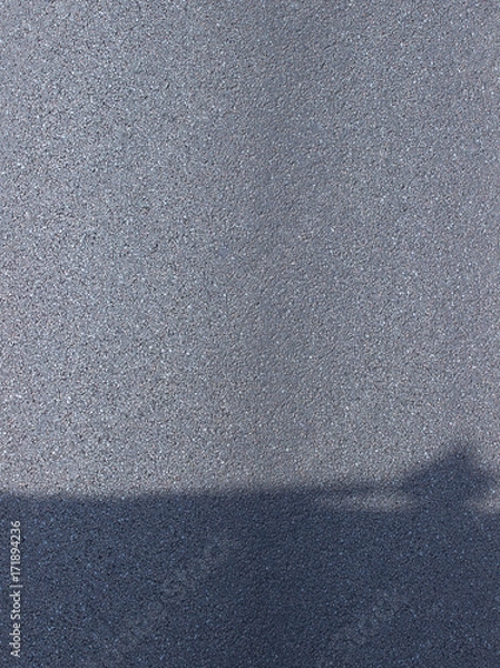 Fototapeta Texture of dry asphalt with shadow