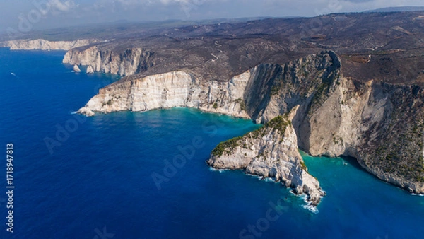 Fototapeta Plakaki beach Zakynthos Greece dramatic aerial view with sheer cliffs turquoise bays rocky headland and endless Ionian Sea under clear blue sky