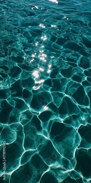 Obraz A stunning view of sunlit ripples casting beautiful patterns on clear turquoise water, creating a serene and tranquil ambiance.