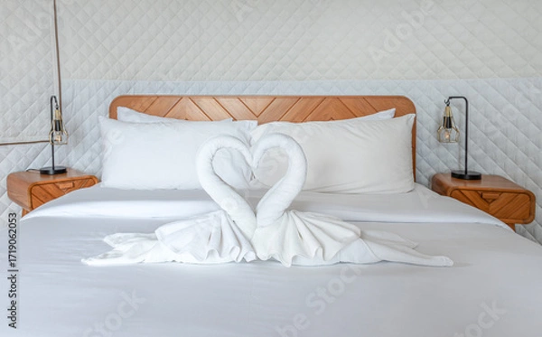 Fototapeta Single bed with heart shaped white towels on the bed
