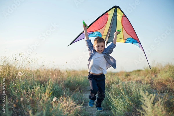 Obraz Beautiful little kid in shirt running with a kite in hands