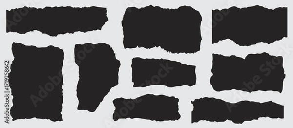 Fototapeta Eight irregular black paper fragments are positioned against a soft gray background, creating a modern texture