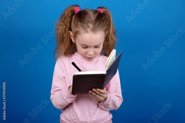 Fototapeta Child Writing in Notebook