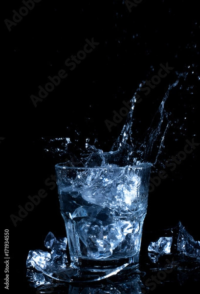 Fototapeta ice cube in the glass of water