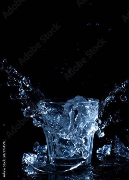 Fototapeta ice cube drops into water