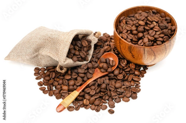 Fototapeta Roasted coffee beans in a jute bag with wooden cup and spoon isolated on white background. Coffee beans background texture.