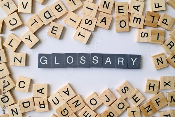 Fototapeta Glossary word in wooden cube blocks, dictionary definition concept, list of terms and meanings, education and knowledge idea