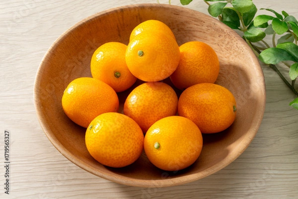 Fototapeta 新鮮な金柑と木目の背景