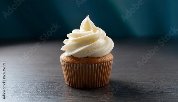 Obraz delicious vanilla cupcake topped with creamy white frosting