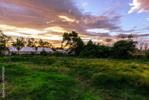 Fototapeta The background of the twilight sunset, the sky has beautiful changes, amidst the green fields and various trees, there is a cool breeze blowing throughout the journey to the viewpoint.