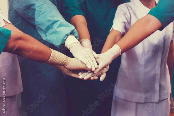 Obraz Doctors and nurses coordinate hands. Concept Teamwork