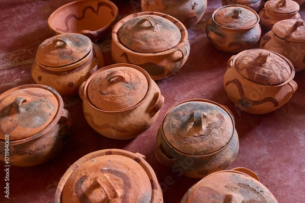 Fototapeta Still warm from the fire, the freshly fired pottery of Huancas emerges from the kiln — glowing with earthy tones, strength, and the mark of ancestral tradition
