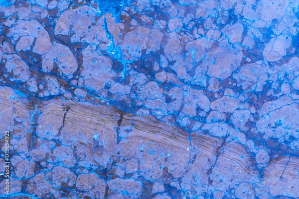 Fototapeta Colorful abstract pattern of blue and brown textures captured from natural stone during daylight hours