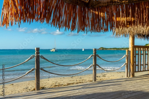 Fototapeta Wooden deck under a palupa thatched-roof on a beach of the Caribbean island of Saint Martin (Sint Maarten), French West Indies